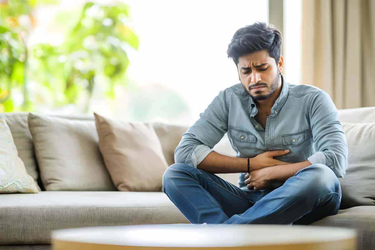 Sensitive stomach man experiencing discomfort due to kidney stones or related issues.